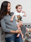 Adorable Cat Print Infant Bodysuit modeled by a parent holding a baby, showcasing a cute cat design by Printify, perfect for baby clothing lovers. Ideal for family gatherings and casual outings, this bodysuit is made of cotton and features a regular fit. A great choice for holiday picks, personalization, and TikTok trends.